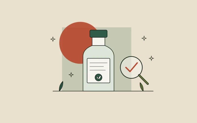 Frasco con etiqueta de ingredientes y una lupa con una marca de verificación: cómo leer la etiqueta de un cosmético